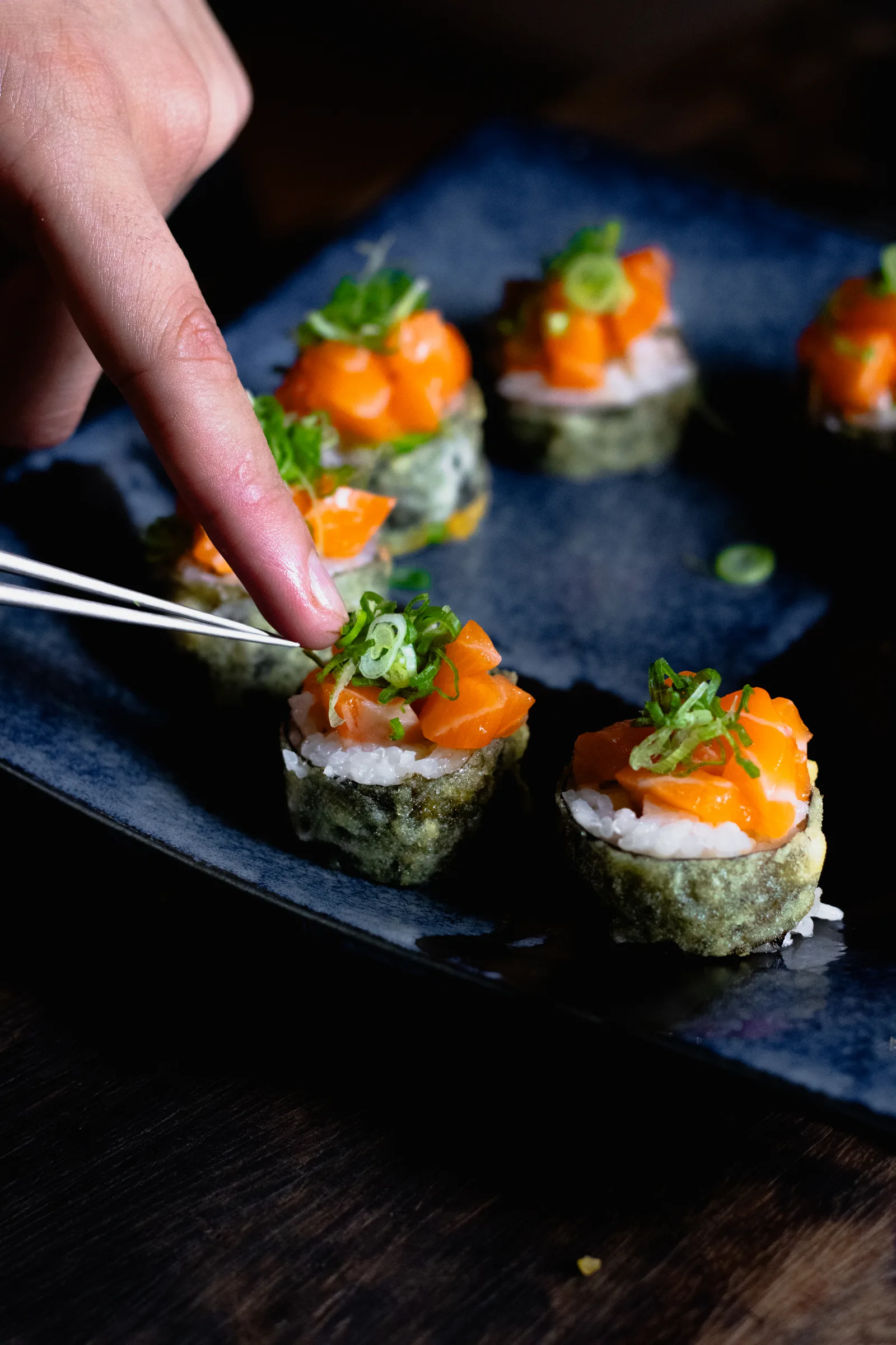 Salmon rolls with chives served by hand at the Nantai bar